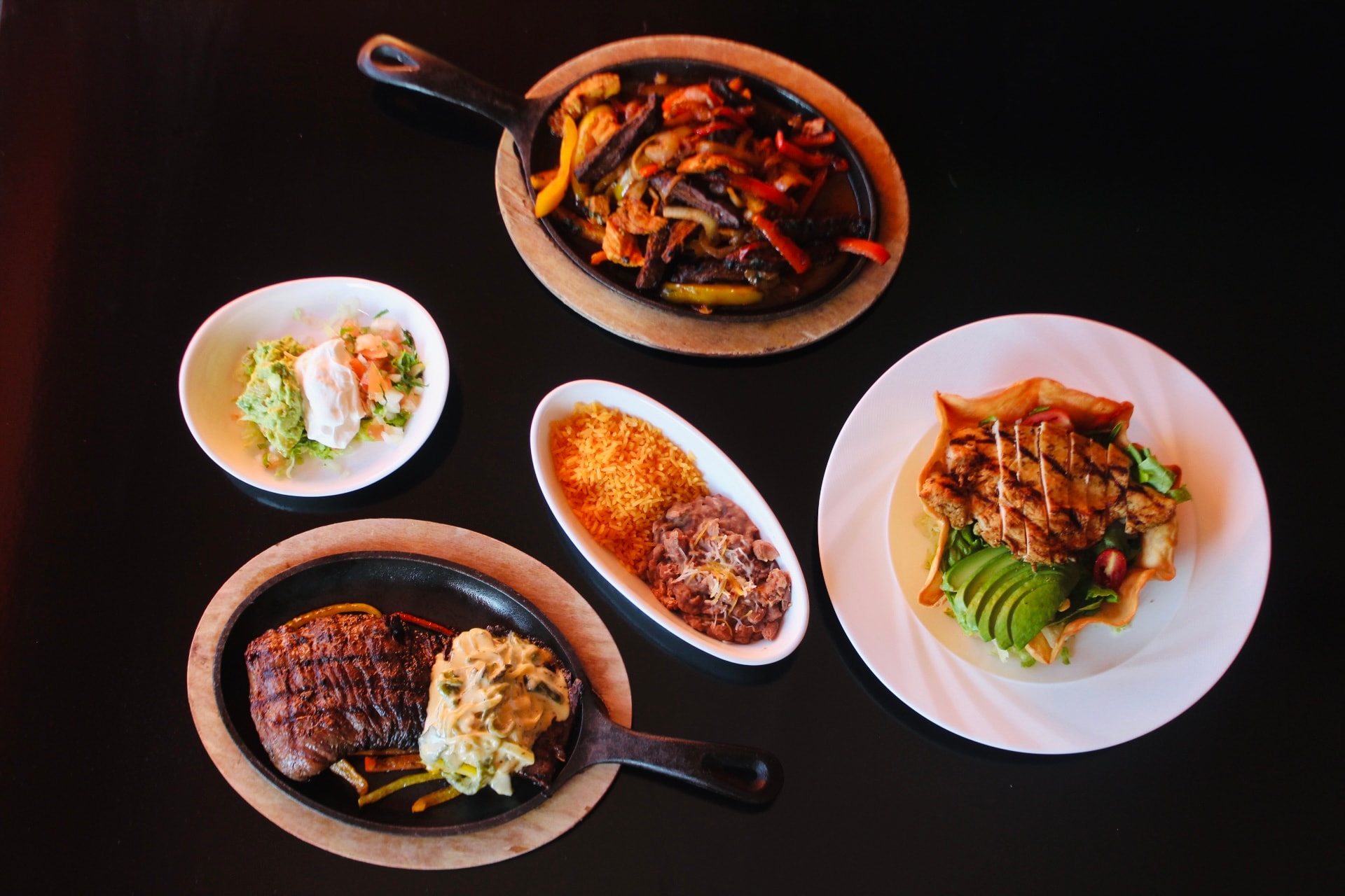 A spread of tacos, fajitas and sides